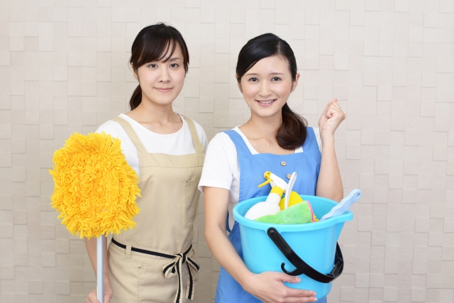 清掃用具を持つ女性